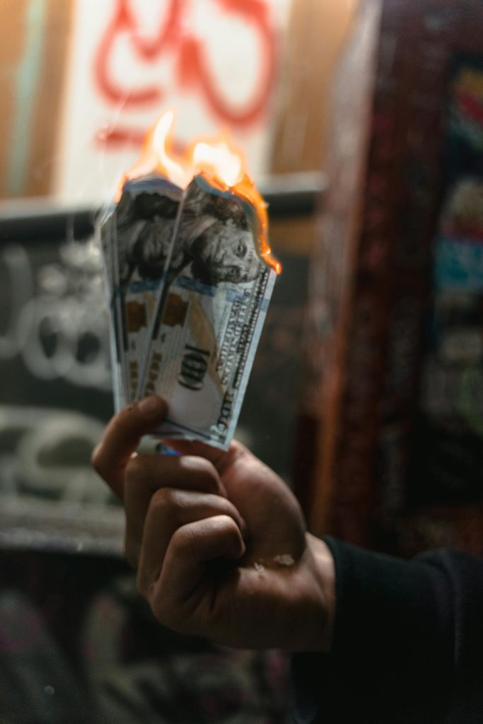 Une photo des billets de banque en feu désignant l'inflation grignotant l'argent des épargnants.